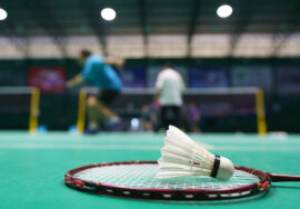 shuttlecock on green badminton playing court 2022 04 08 12 50 00 utc
