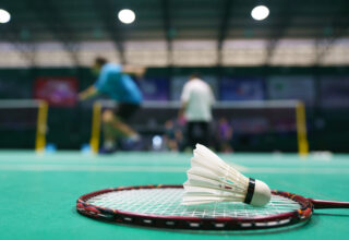 shuttlecock on green badminton playing court 2022 04 08 12 50 00 utc