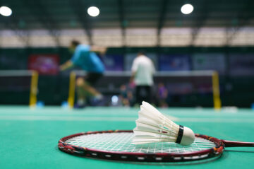shuttlecock on green badminton playing court 2022 04 08 12 50 00 utc